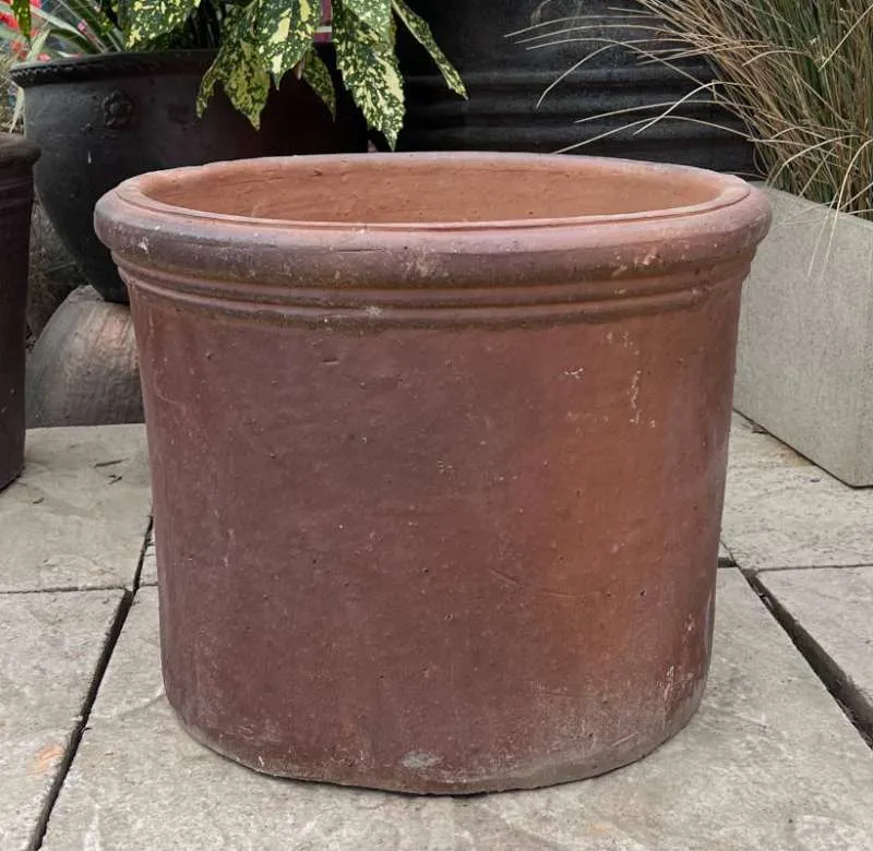 A rustic clay cylinder pot